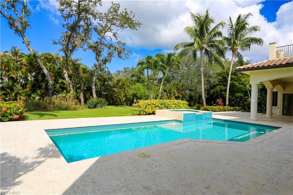 823 Cassena Road Naples, FL 34108 - Photo 11 of 50 a view of swimming pool with lawn chairs and plants