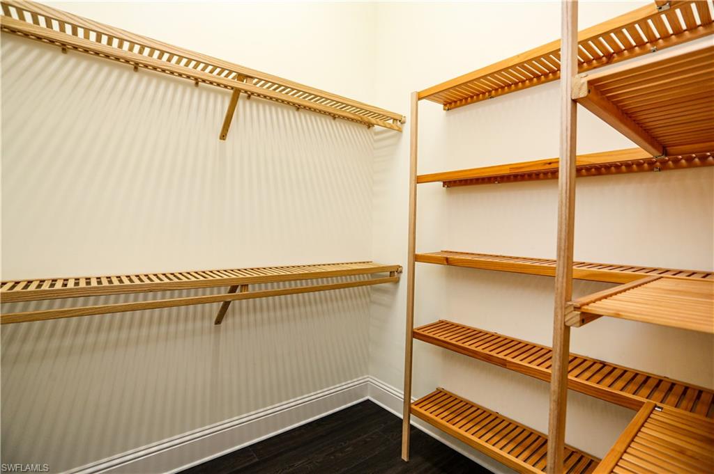 823 Cassena Road Naples, FL 34108 - Photo 22 of 50 a view of walk in closet with clothes and shoes