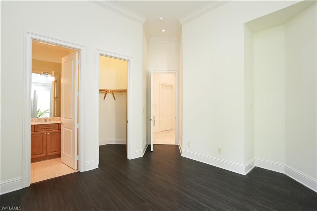 823 Cassena Road Naples, FL 34108 - Photo 29 of 50 a view of an empty room with wooden floor and a window