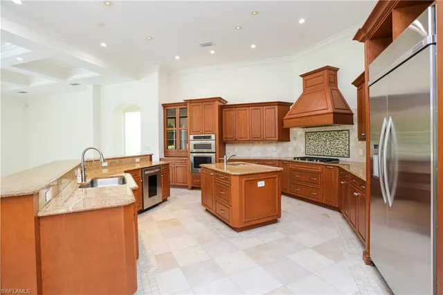 a large kitchen with stainless steel appliances lots of counter top space