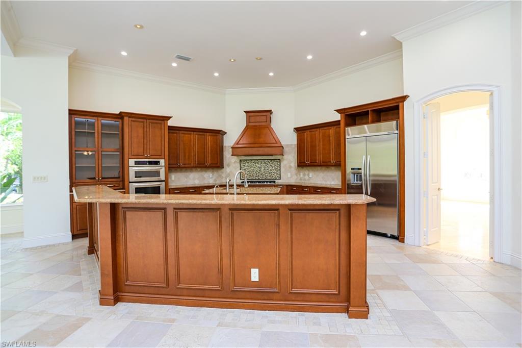 823 Cassena Road Naples, FL 34108 - Photo 33 of 50 a kitchen with stainless steel appliances granite countertop a stove and a refrigerator