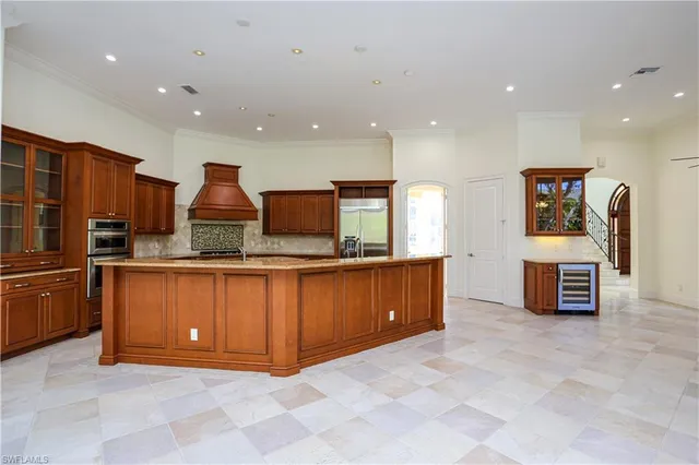 a large kitchen with stainless steel appliances granite countertop a large counter top and a stove