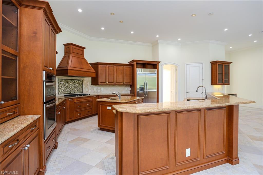 823 Cassena Road Naples, FL 34108 - Photo 35 of 50 a kitchen with stainless steel appliances granite countertop a sink and cabinets