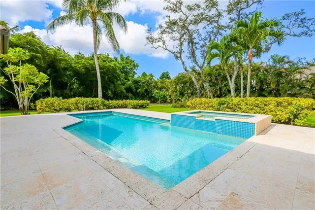 a view of a swimming pool with a yard