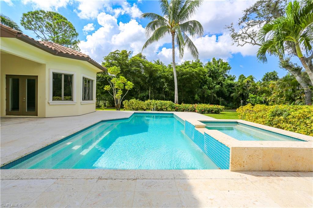 823 Cassena Road Naples, FL 34108 - Photo 6 of 50 a view of a swimming pool with a yard