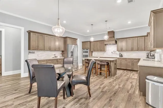 a kitchen with stainless steel appliances granite countertop a sink dishwasher stove and cabinets