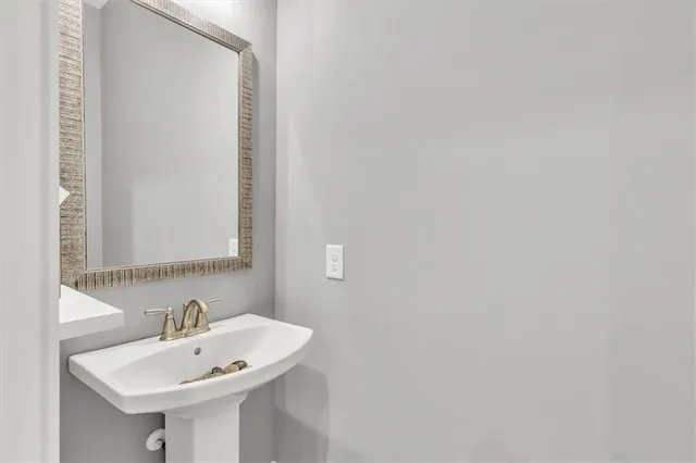 a bathroom with a granite countertop sink mirror and a