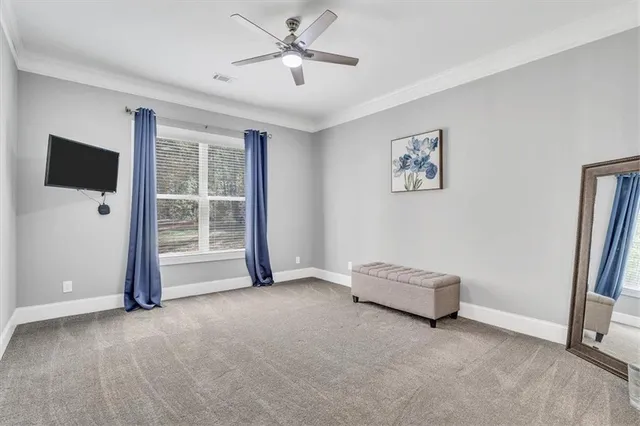 a bedroom with a large bed and a chandelier