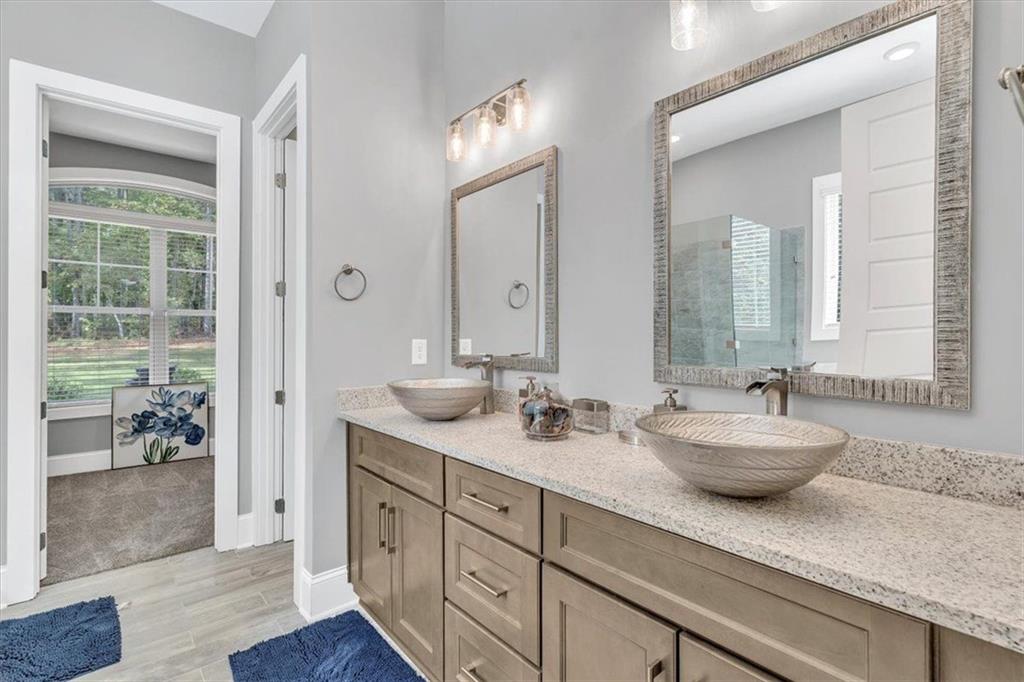590 Eskew Road McDonough, GA 30252 - Photo 27 of 59 a bathroom with a granite countertop sink mirror and a
