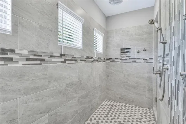 a bathroom with a granite countertop sink double vanity and a mirror