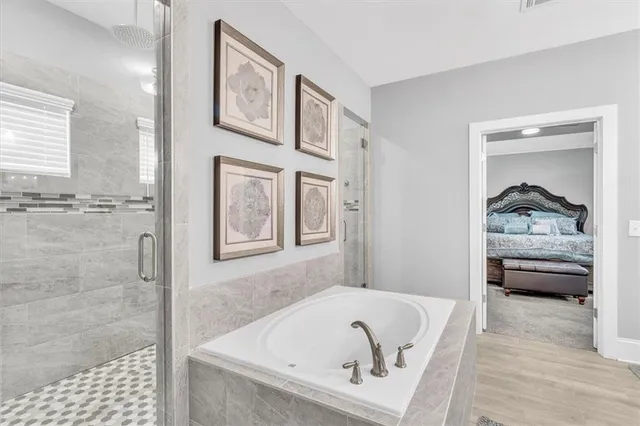 a view of an empty room with furniture and a window