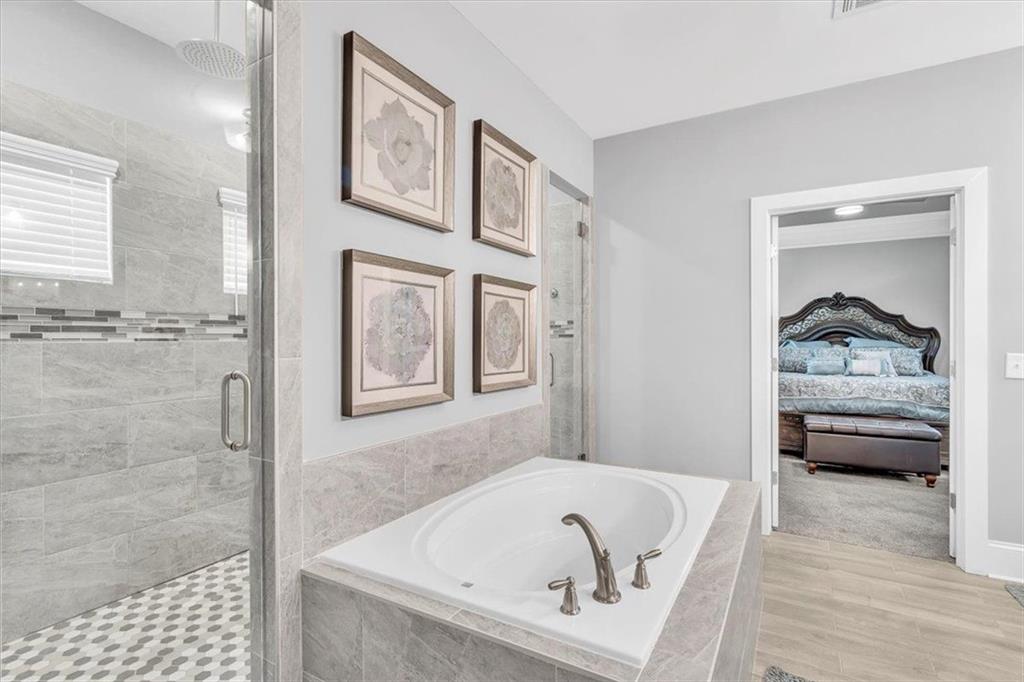 590 Eskew Road McDonough, GA 30252 - Photo 38 of 59 a bathroom with a tub and a shower