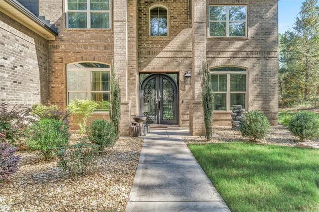 a front view of a house with a garden