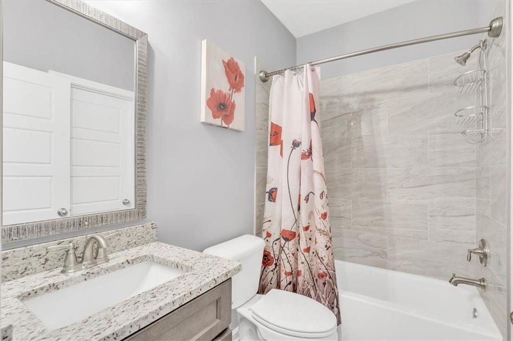 590 Eskew Road McDonough, GA 30252 - Photo 42 of 59 a bathroom with a granite countertop sink and a mirror