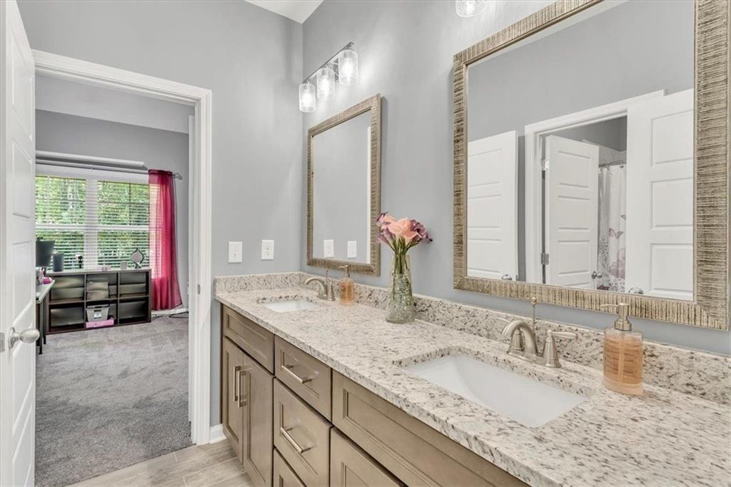 590 Eskew Road McDonough, GA 30252 - Photo 44 of 59 a bathroom with a granite countertop sink double vanity and a mirror
