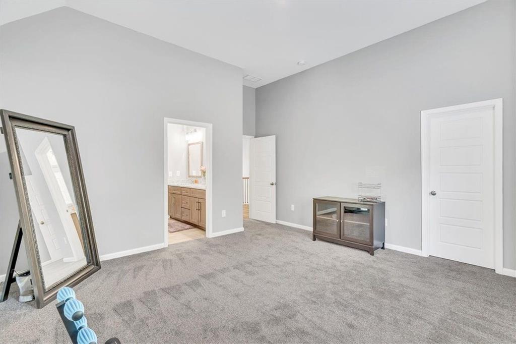 590 Eskew Road McDonough, GA 30252 - Photo 46 of 59 a view of an empty room with furniture and a window