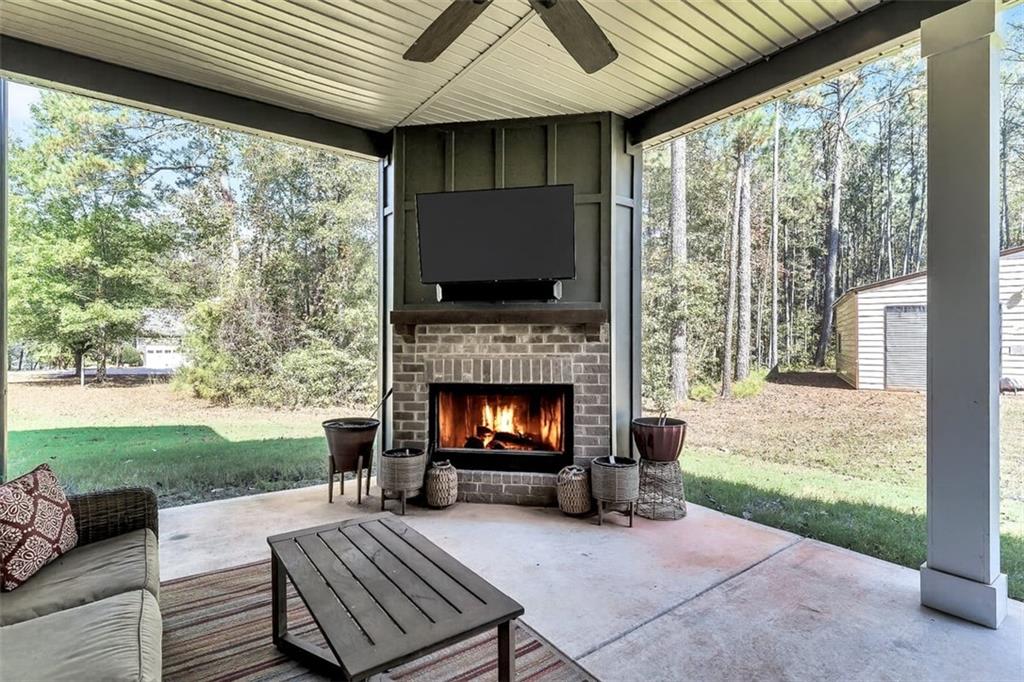 590 Eskew Road McDonough, GA 30252 - Photo 48 of 59 a living room with a fireplace and a floor