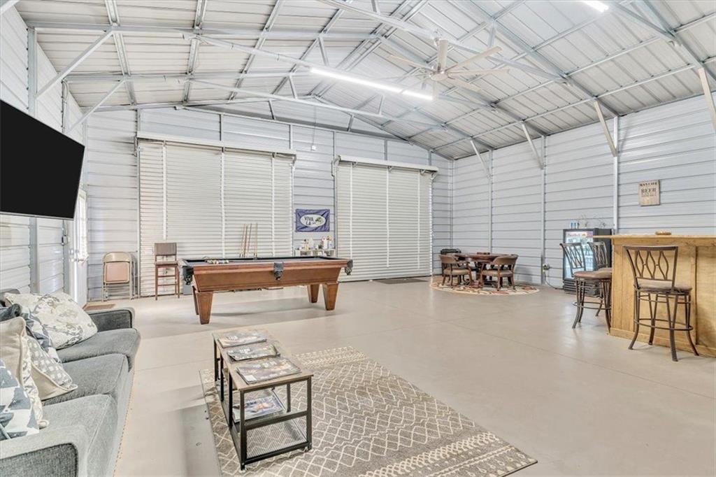 590 Eskew Road McDonough, GA 30252 - Photo 52 of 59 a living room with furniture and a flat screen tv