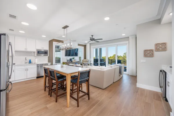 a kitchen with a table chairs refrigerator and cabinets
