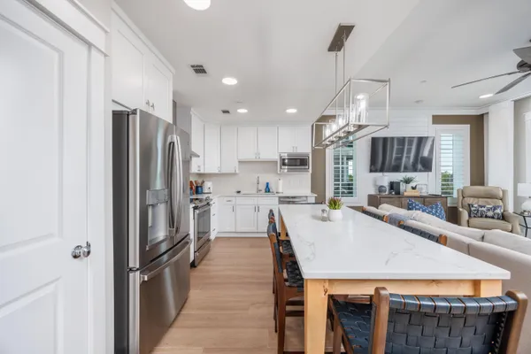 a kitchen with refrigerator a sink and a counter top space