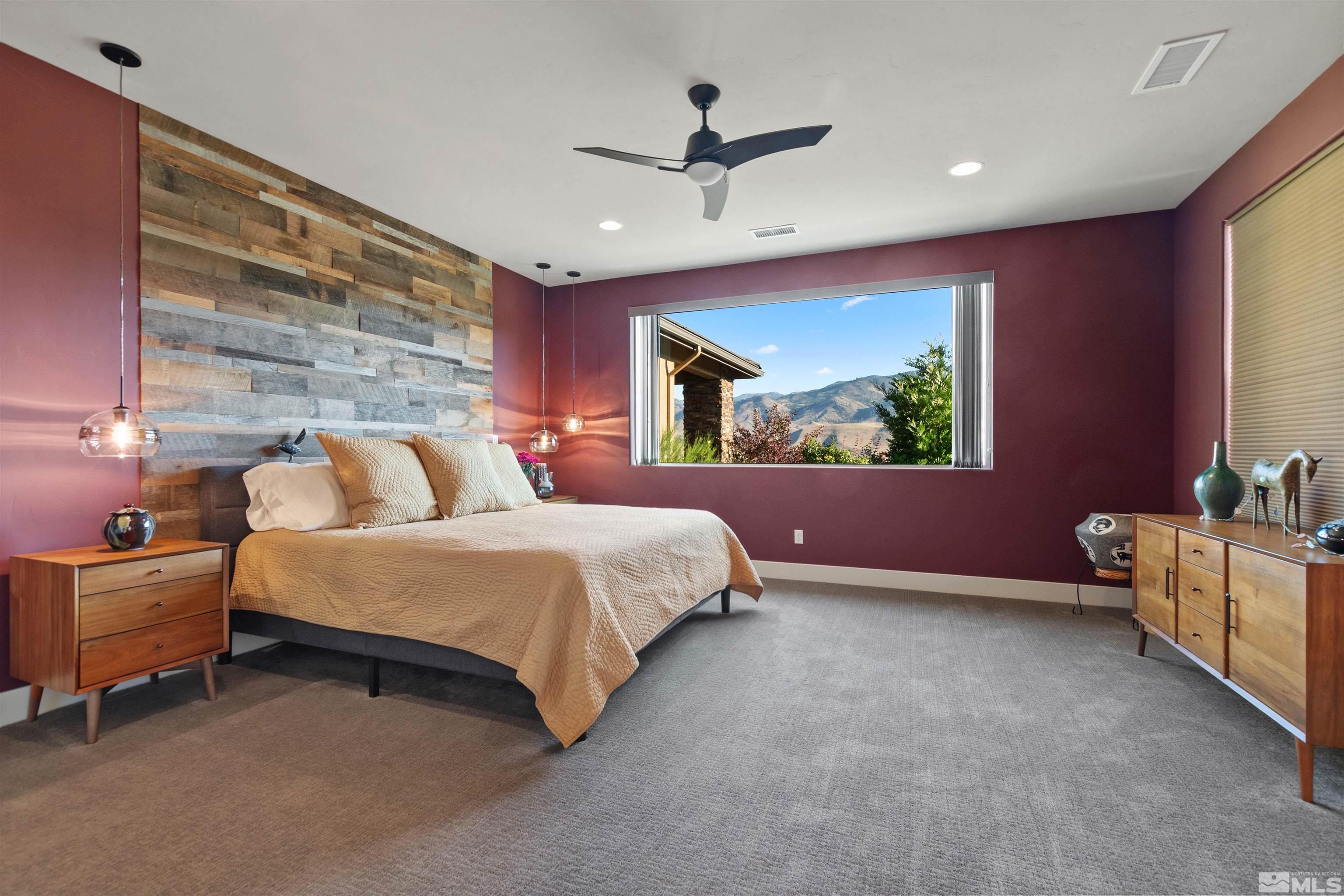1575 Scott Valley Road Reno, NV 89523 - Photo 16 of 40 a spacious bedroom with a bed and a chandelier