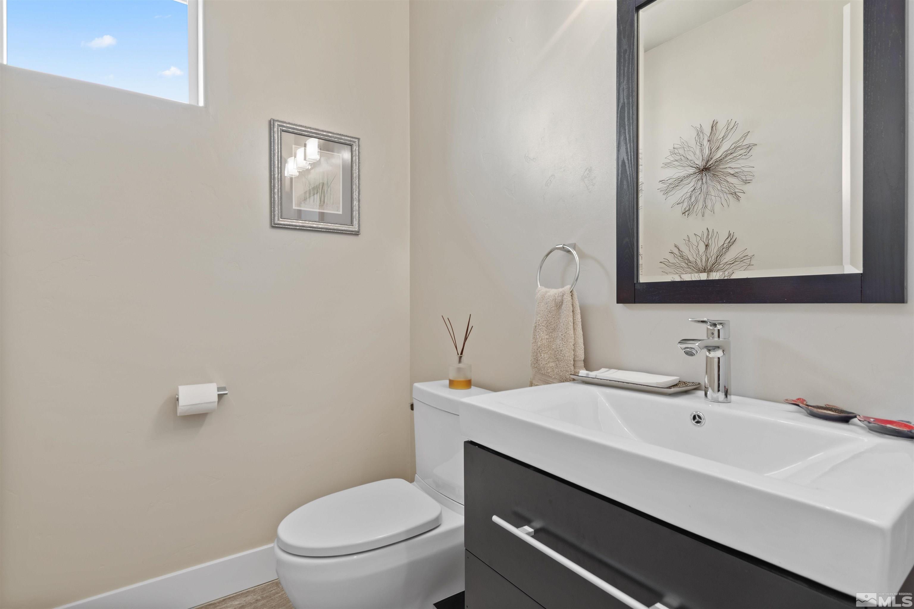 1575 Scott Valley Road Reno, NV 89523 - Photo 18 of 40 a bathroom with a sink a toilet and a mirror