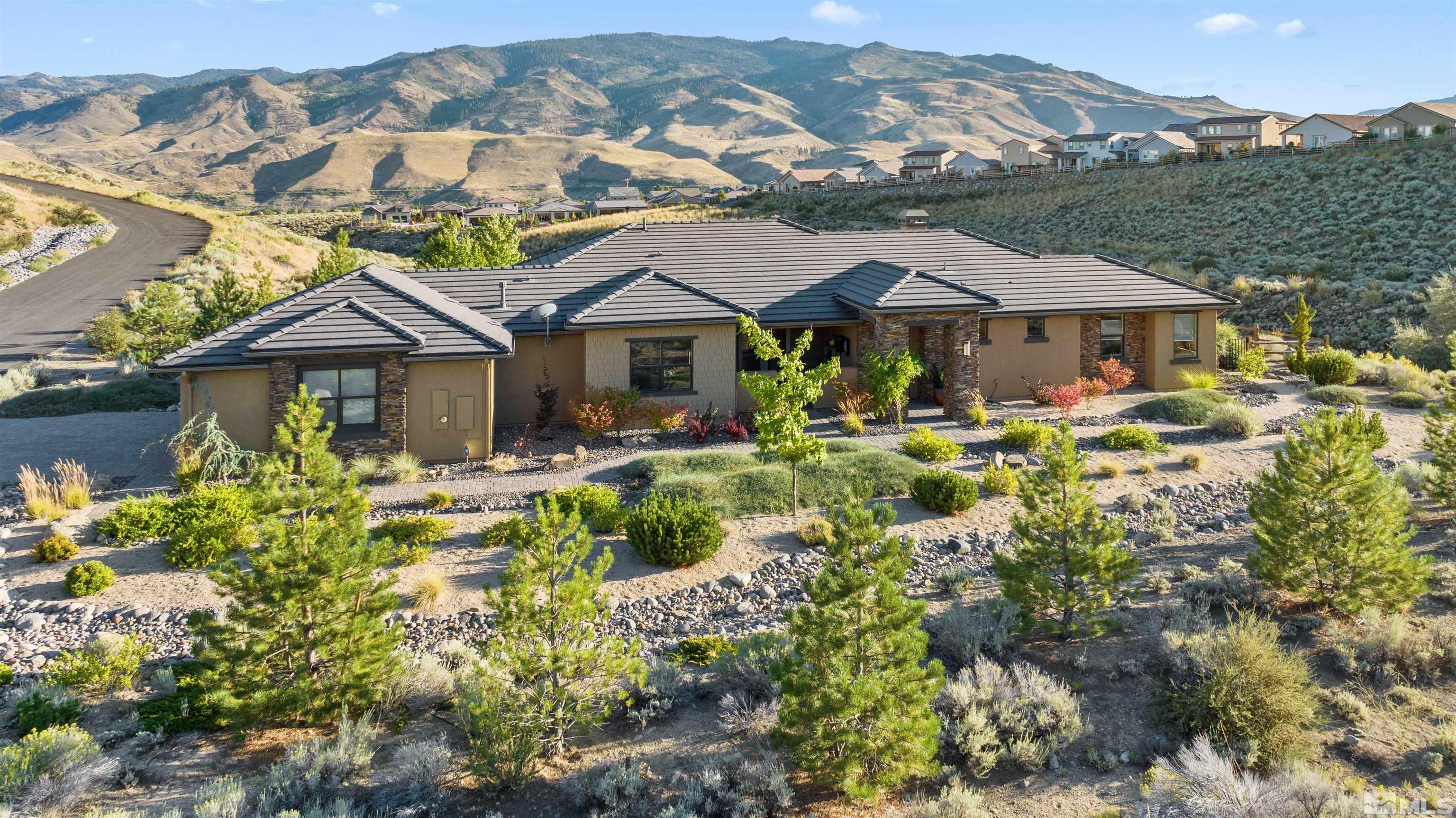 1575 Scott Valley Road Reno, NV 89523 - Photo 2 of 40 a front view of a house with a yard and mountain