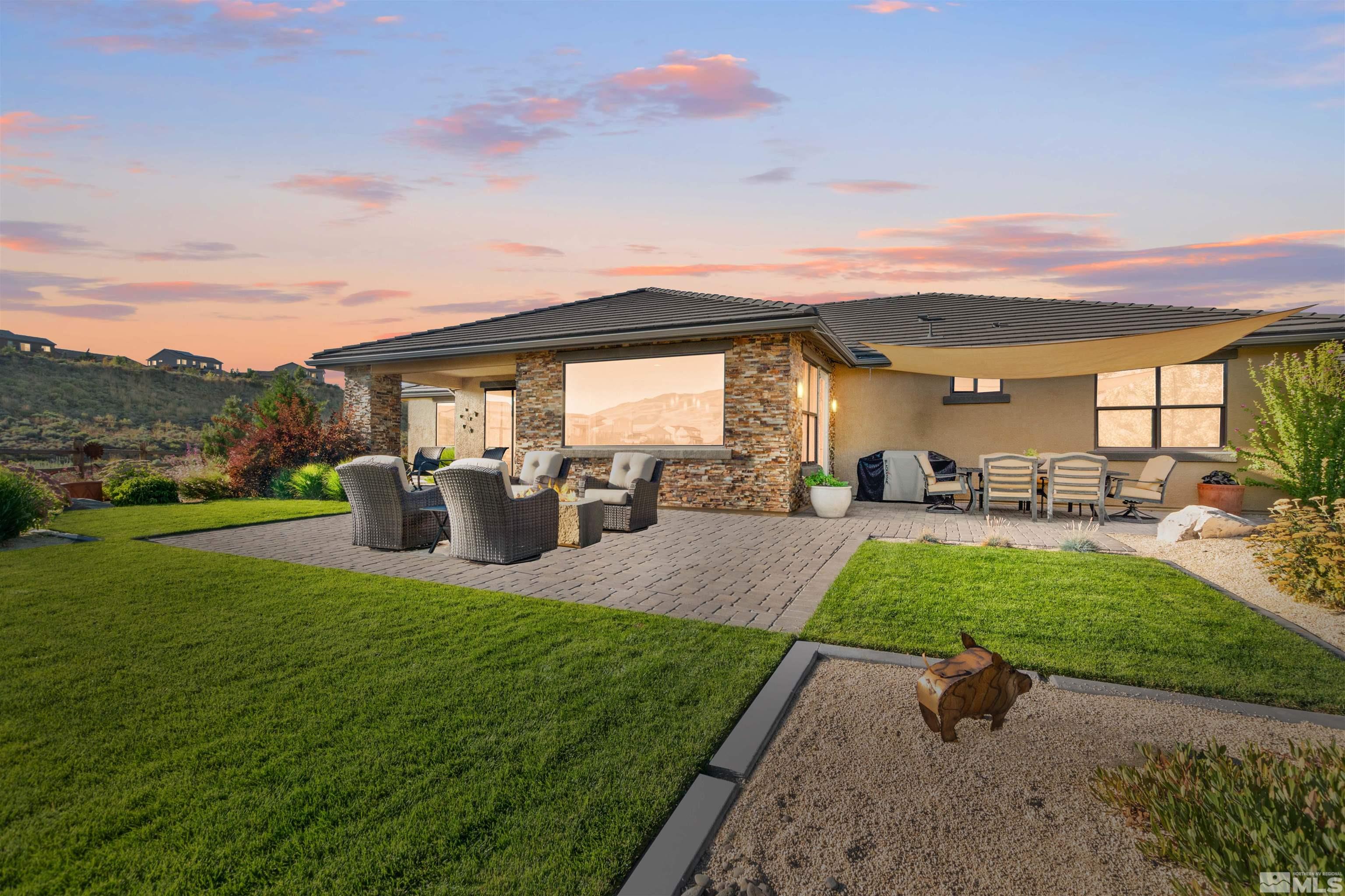 1575 Scott Valley Road Reno, NV 89523 - Photo 32 of 40 a view of a patio with table and chairs potted plants and a big yard