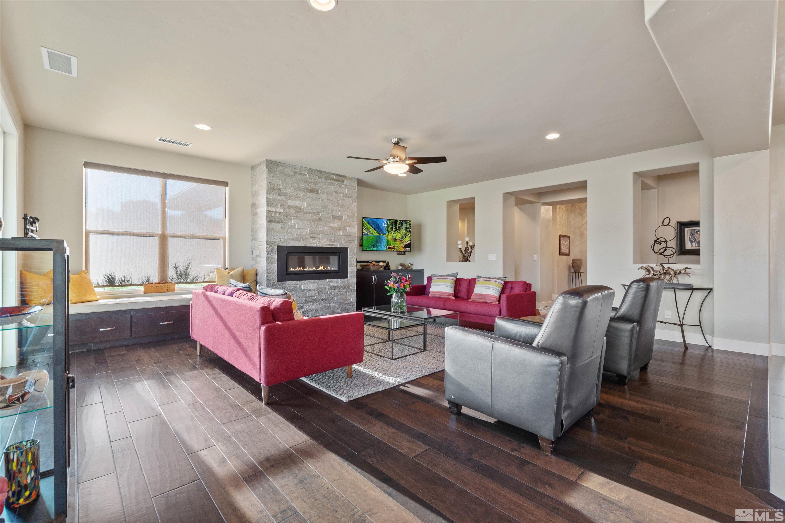 1575 Scott Valley Road Reno, NV 89523 - Photo 9 of 40 a living room with furniture a fireplace and a table