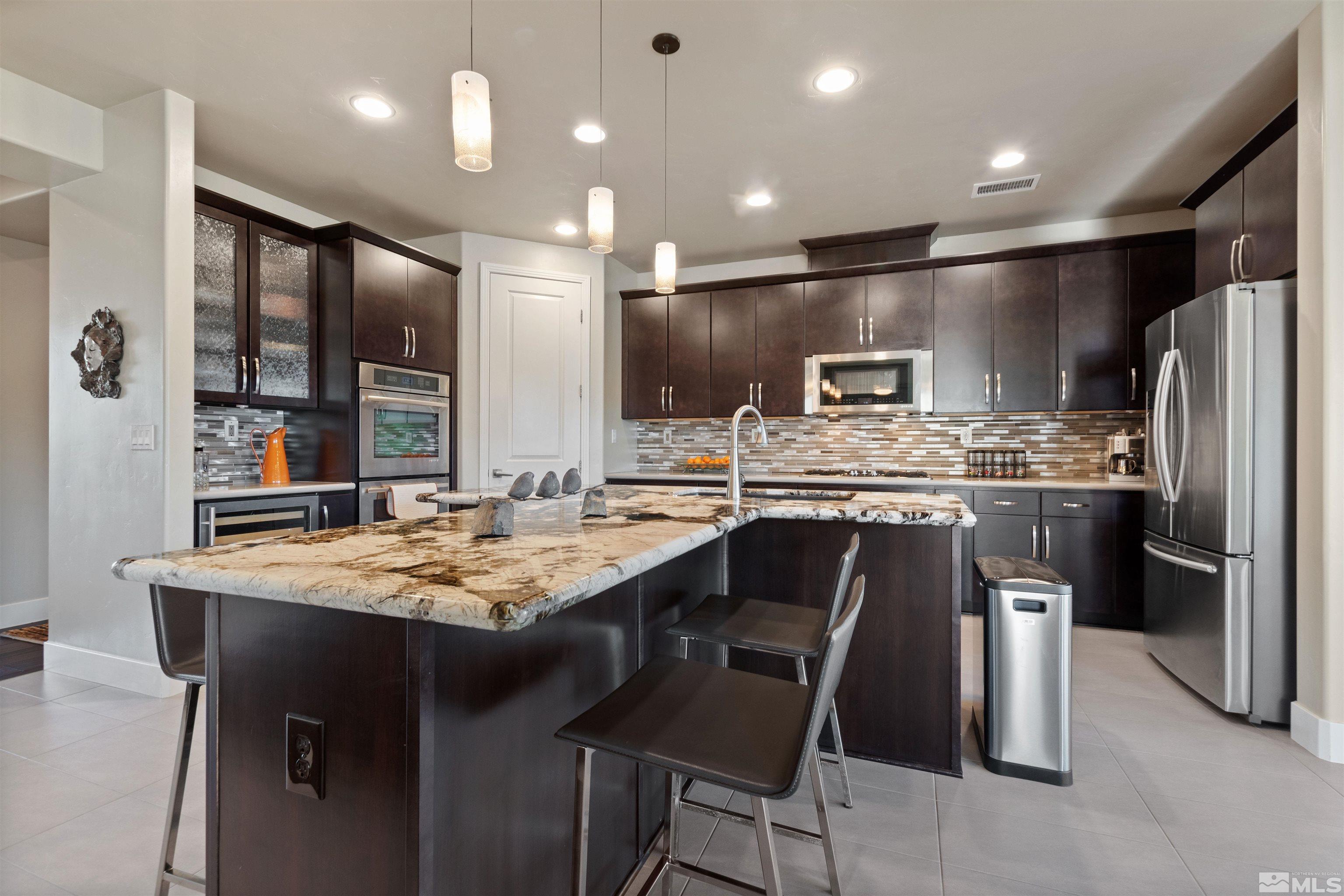 1575 Scott Valley Road Reno, NV 89523 - Photo 10 of 40 a kitchen with kitchen island stainless steel appliances a sink stove and refrigerator