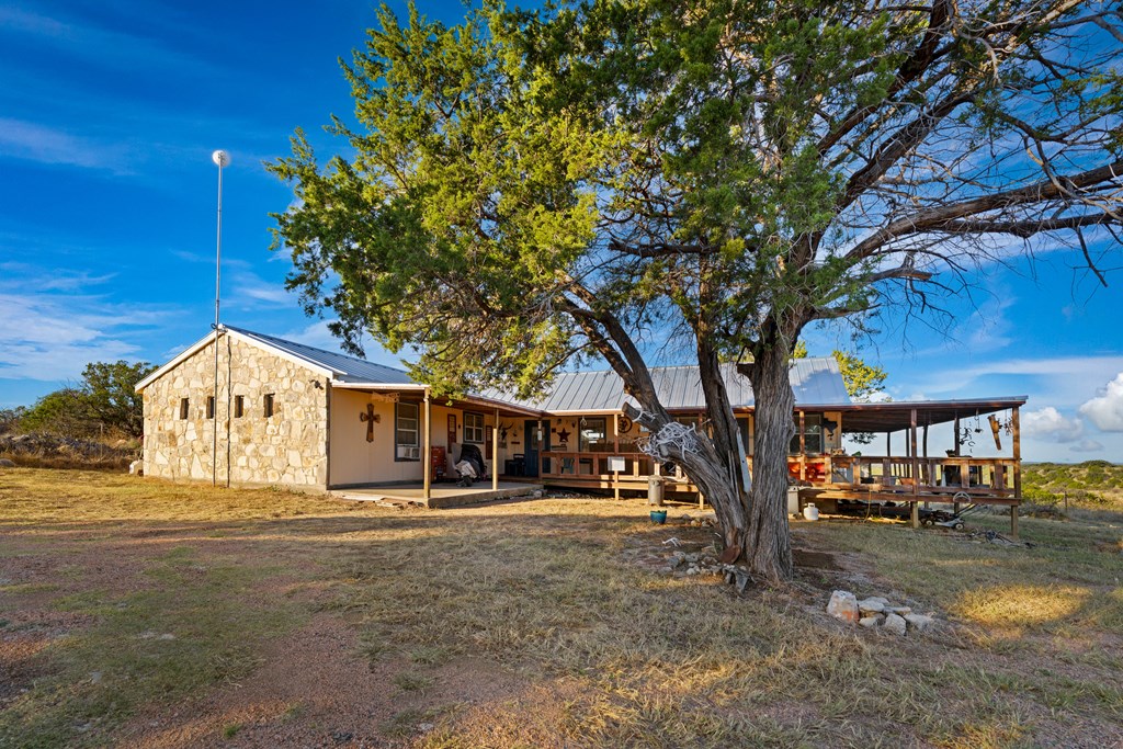 917 Bear Springs Road Mason, TX 76856 - Photo 19 of 38 a front view of a house with a yard tree and outdoor seating
