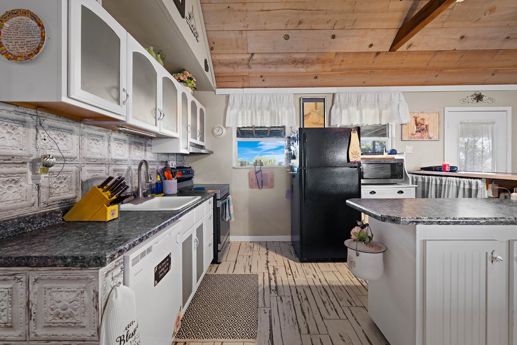 917 Bear Springs Road Mason, TX 76856 - Photo 24 of 38 a kitchen with a sink dishwasher a refrigerator and a stove