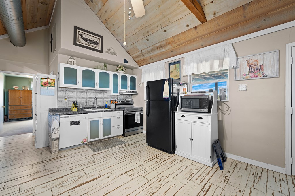917 Bear Springs Road Mason, TX 76856 - Photo 25 of 38 a kitchen with stainless steel appliances granite countertop a refrigerator and a stove top oven