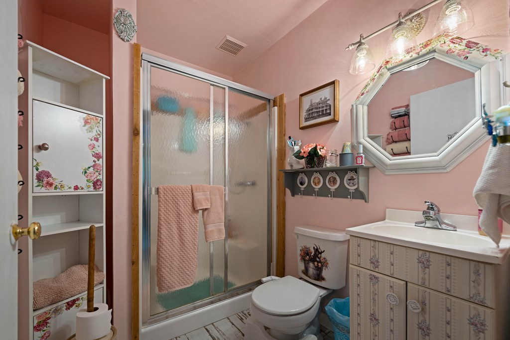 917 Bear Springs Road Mason, TX 76856 - Photo 32 of 38 a bathroom with a toilet a sink a glass door and shower