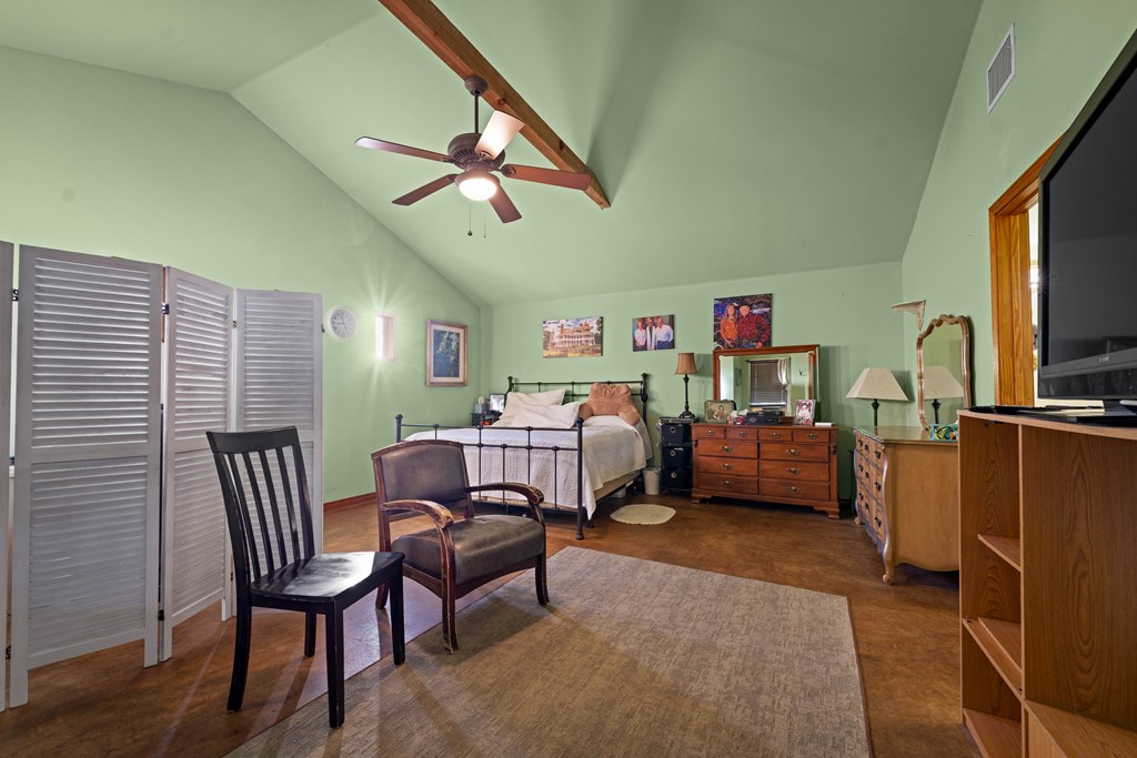 917 Bear Springs Road Mason, TX 76856 - Photo 33 of 38 a bedroom with furniture and a flat screen tv
