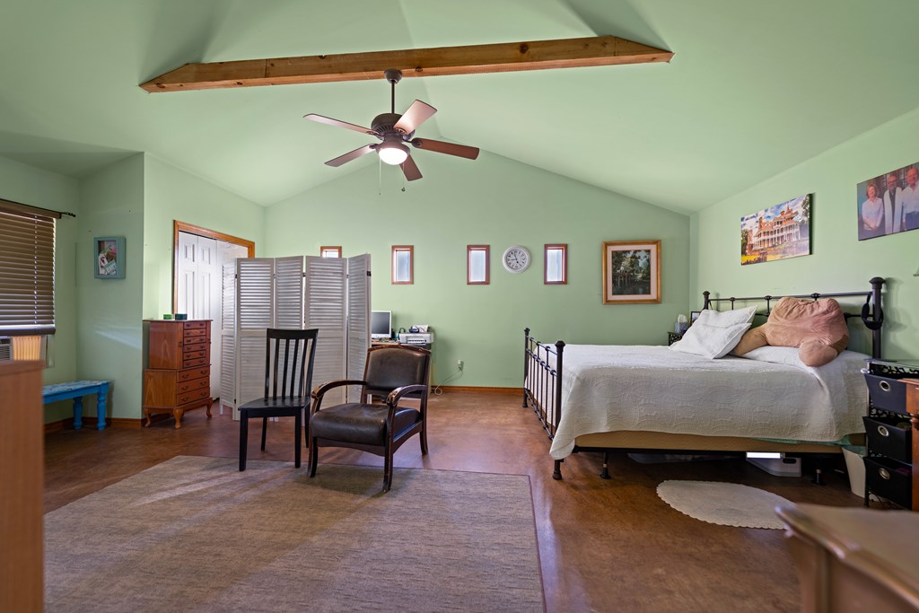 917 Bear Springs Road Mason, TX 76856 - Photo 34 of 38 a bed room with a bed and a chandelier