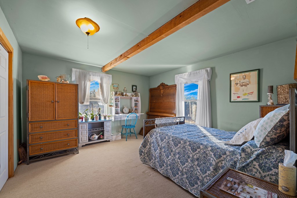 917 Bear Springs Road Mason, TX 76856 - Photo 36 of 38 a bedroom with a bed and a chandelier