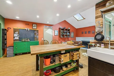a living room with furniture a flat screen tv and a large window