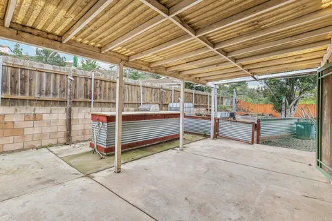a view of a house with a small yard and plants