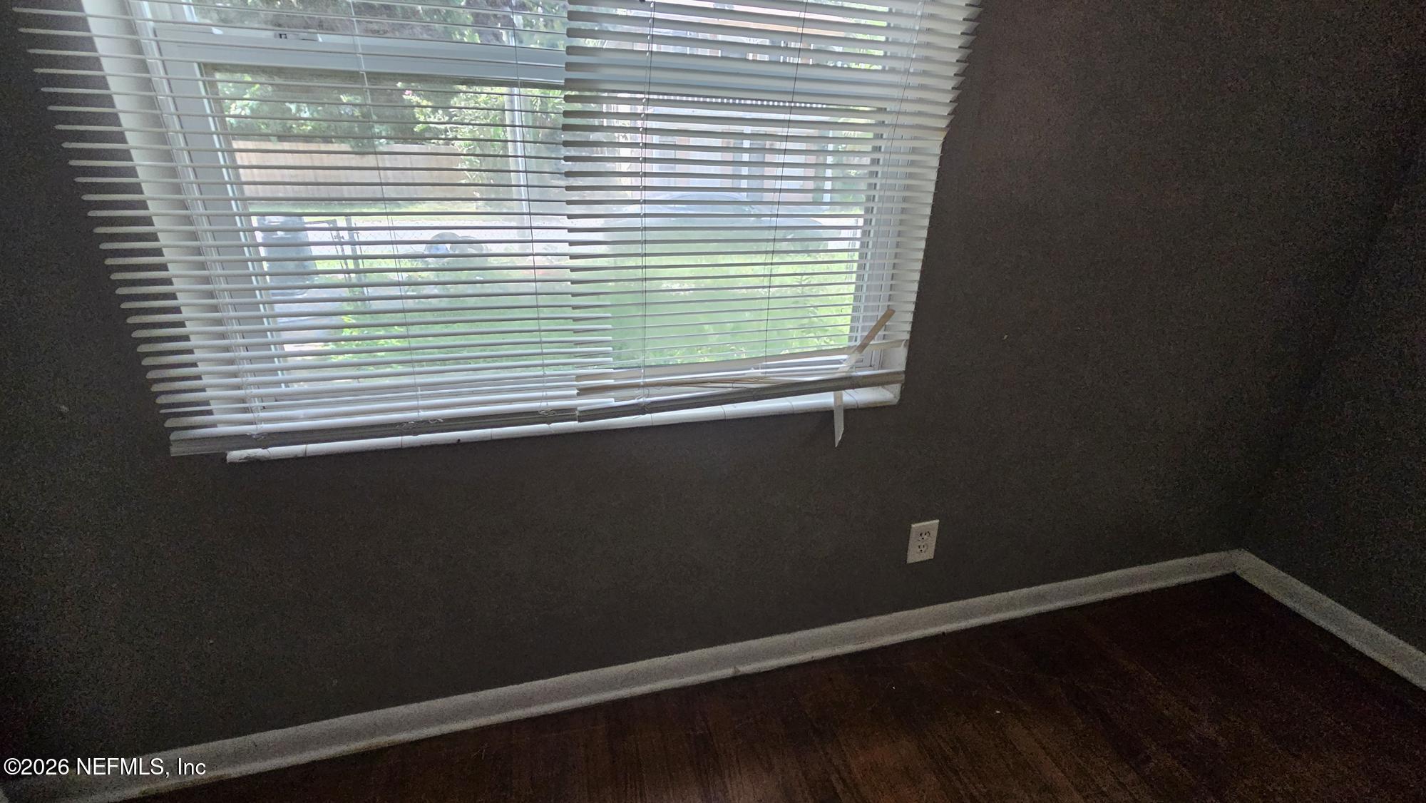 2727 North N Davis Rd Street Jacksonville, FL 32206 - Photo 11 of 31 a view of a small space with wooden floor and a window