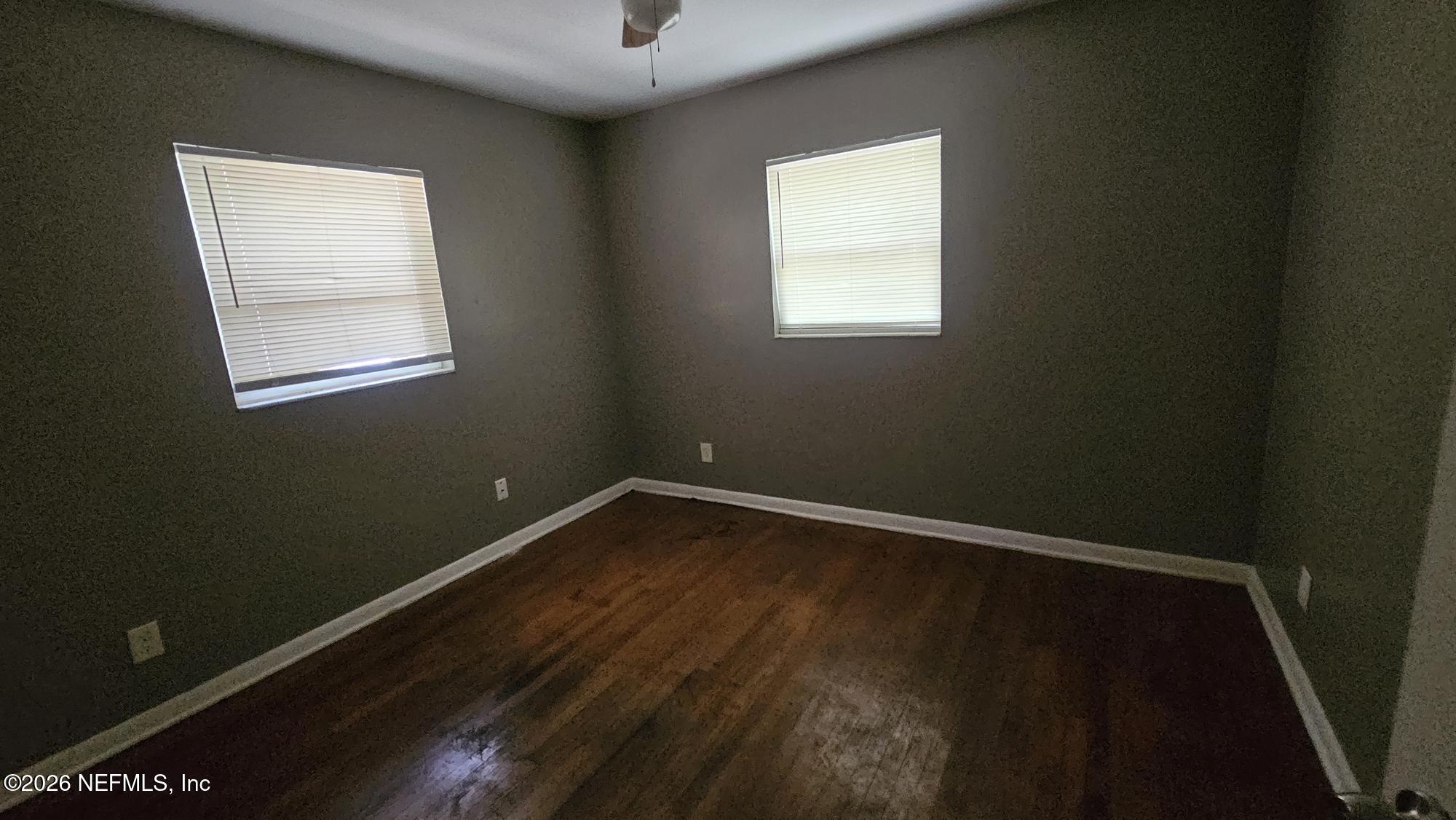 2727 North N Davis Rd Street Jacksonville, FL 32206 - Photo 18 of 31 a view of an empty room with wooden floor and a window