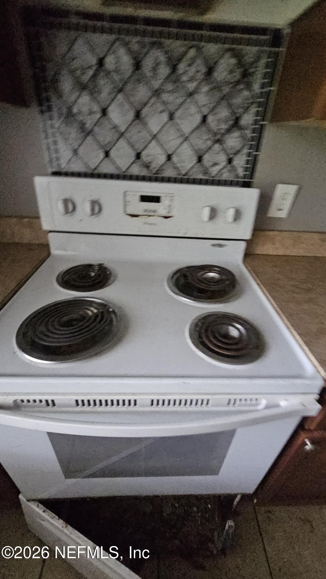 2727 North N Davis Rd Street Jacksonville, FL 32206 - Photo 31 of 31 a close view of a stove a microwave and cabinets