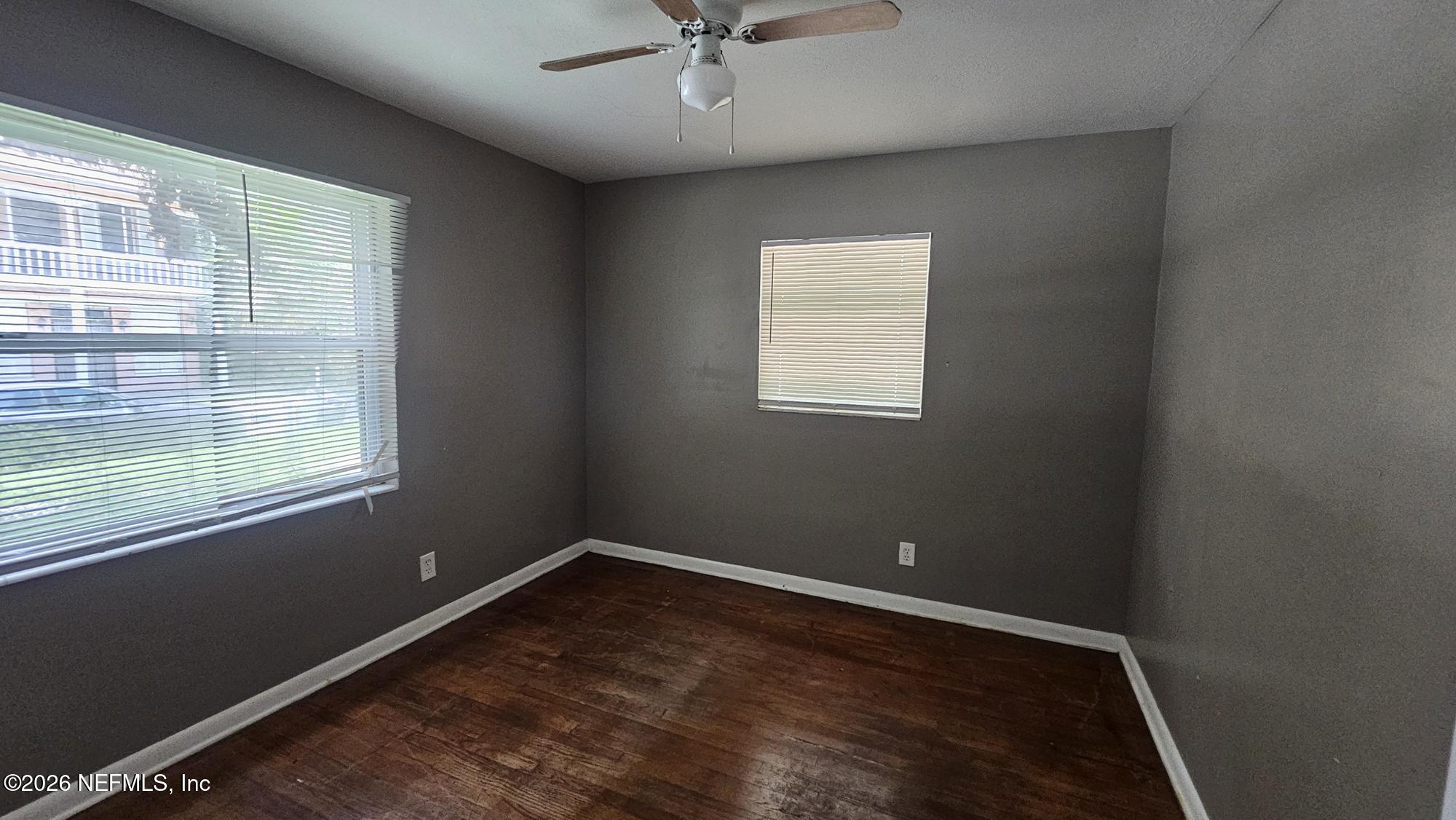 2727 North N Davis Rd Street Jacksonville, FL 32206 - Photo 10 of 31 an empty room with a window and a ceiling fan