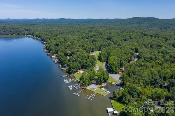 a view of a fountain in front of a house with a yard