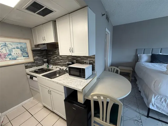 a bathroom with a shower and a sink