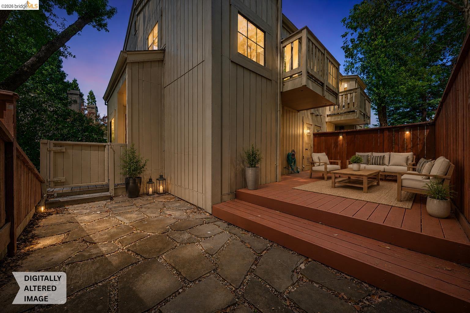 261 Redhawk Road Novato, CA 94949 - Photo 6 of 47 Private outdoor patio featuring a wood deck, stone paver courtyard, and a privacy fence with integrated lighting