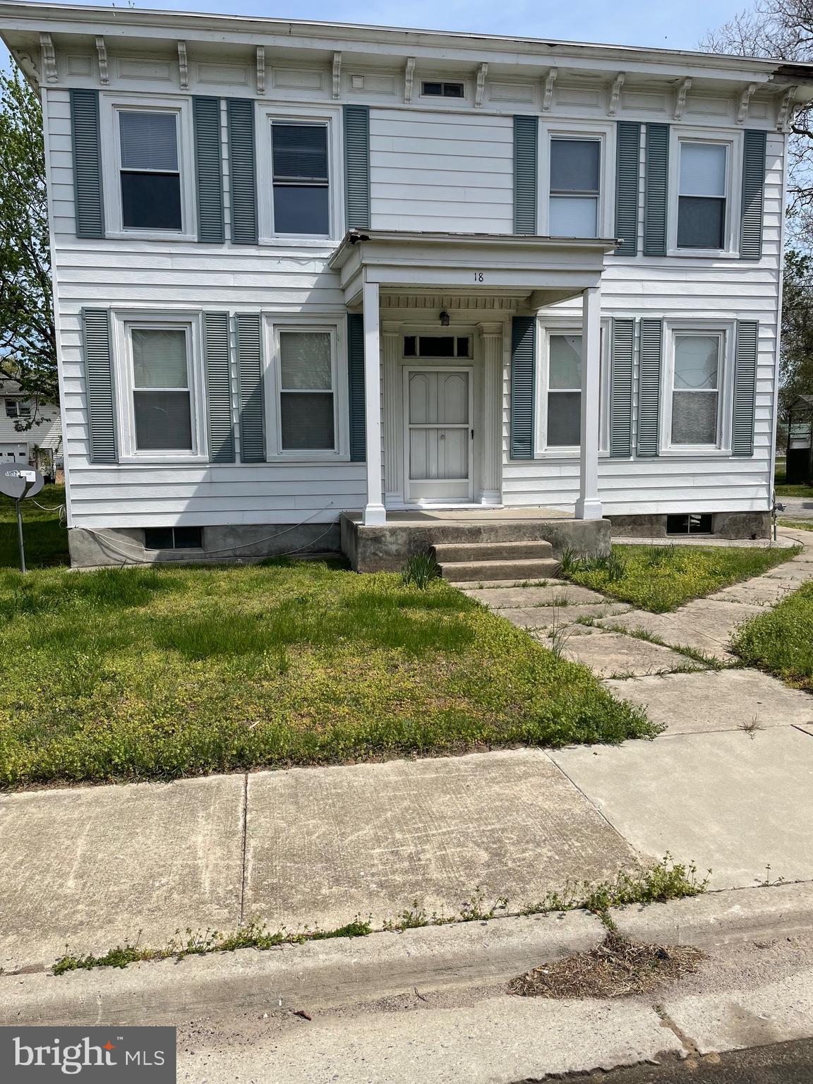 a view of a brick house with a yard