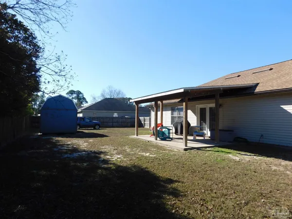 a view of a house with backyard and sitting area