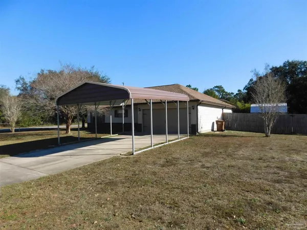 a view of a house with a yard and sitting area