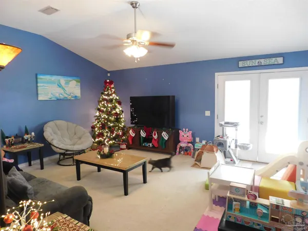 a living room with furniture and a flat screen tv